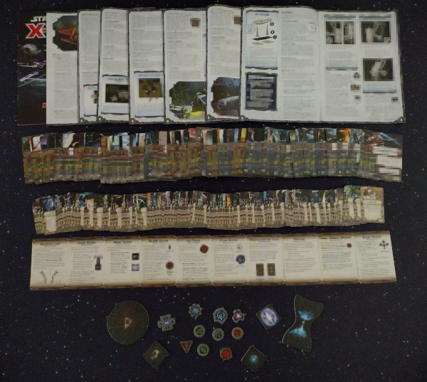 Picture of large amount of extend X-Wing rules, cards, tokens